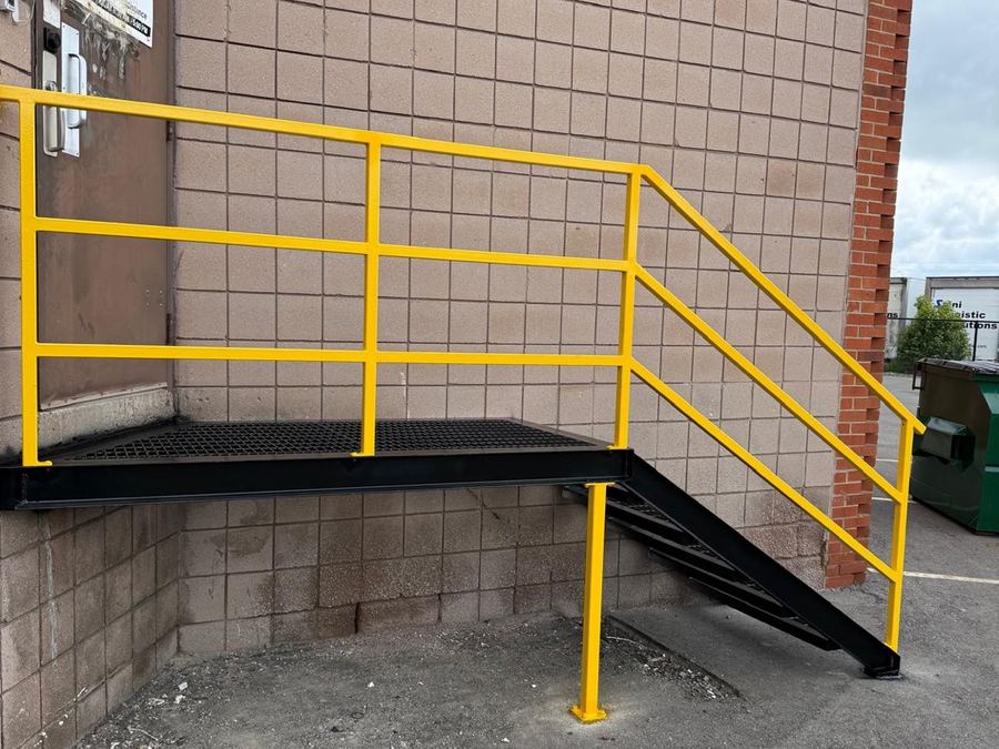 The same industrial access stair built and installed against the building.