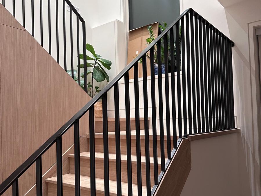 The same stair built, with vertical pickets and a flat handrail.