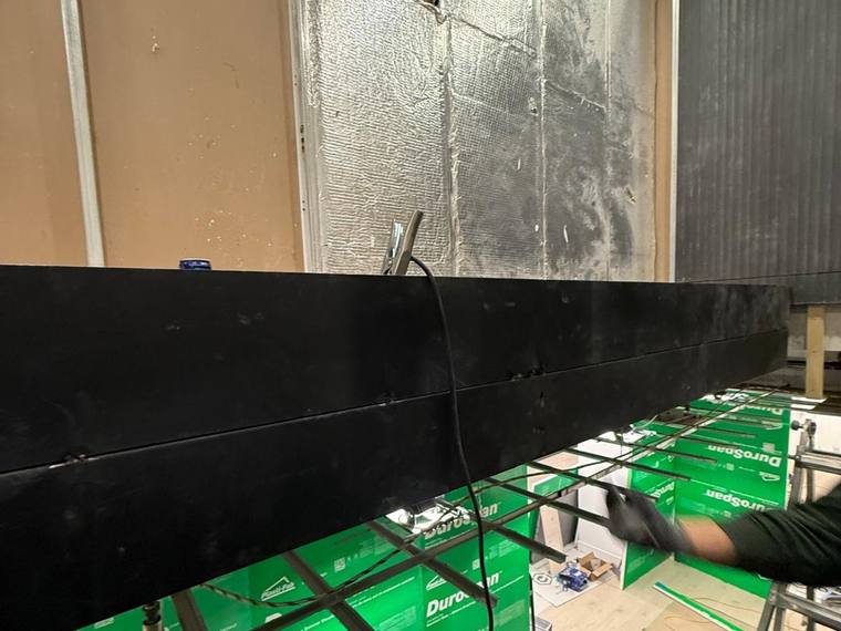 Laminated glass panels in delivery crates on site.