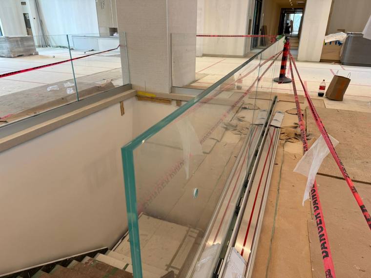 Glass guard along a commercial stair flight.