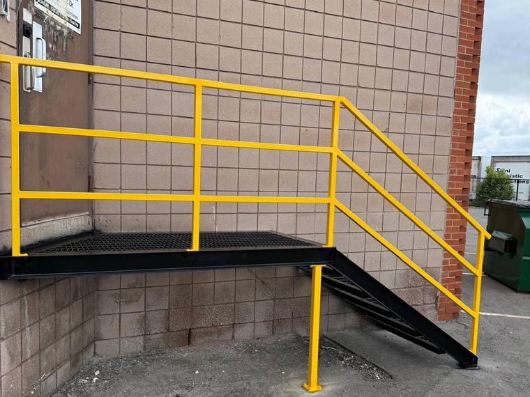 Installed industrial access stair seen from the side.