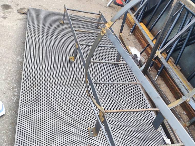 Steel access stair with an expanded mesh guard.