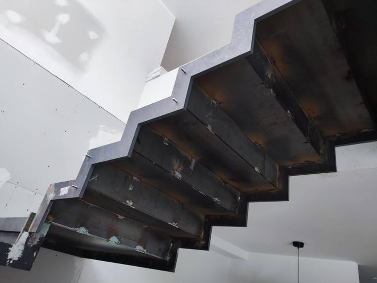 Finished steel stair with floating treads.