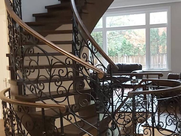 Curved staircase railing running two storeys.