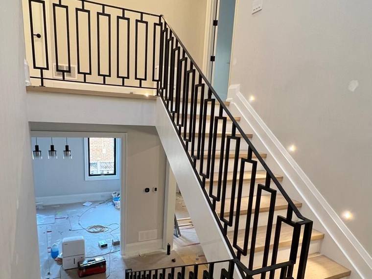 Interior stair and landing guard in black iron.