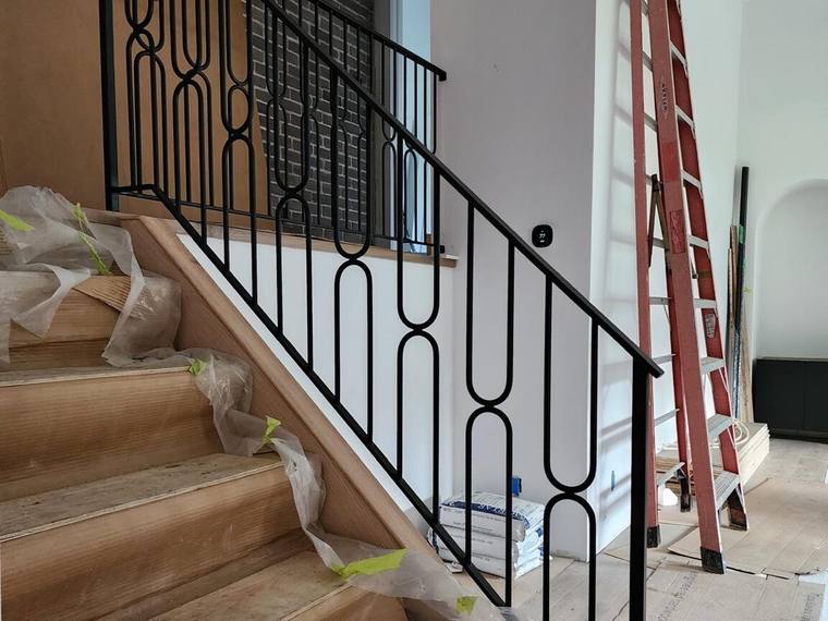 Stair guard with a circle pattern in black steel.