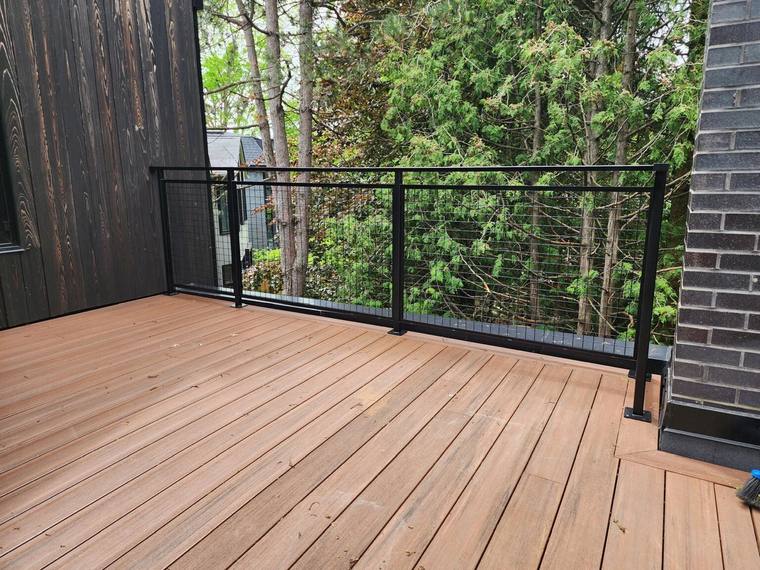 Deck guard with horizontal infill overlooking woodland.
