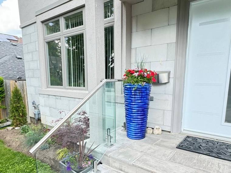 Glass and stainless steel railing at a house entrance.