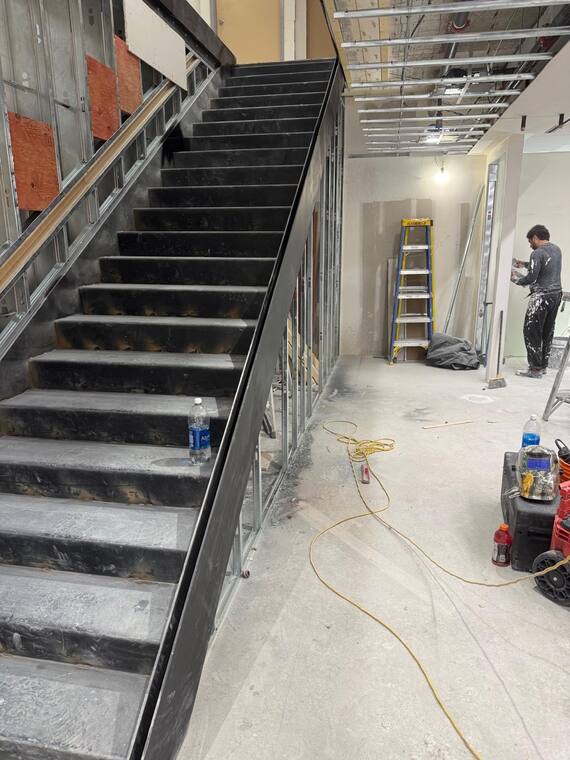 Steel stair being installed on site.
