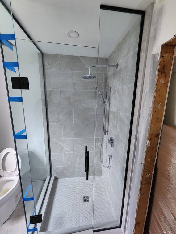Frameless glass shower enclosure.