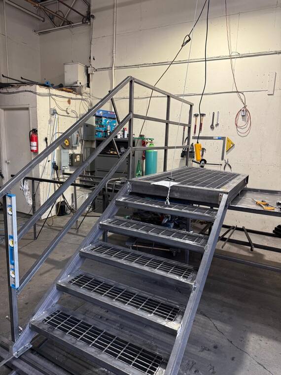 Industrial steel stair under fabrication in the shop.